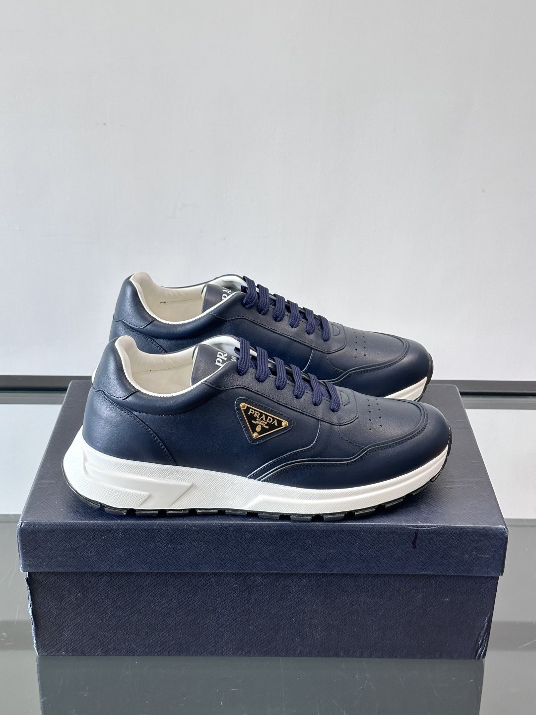 Prada Triangle Plaque Low-Top Sneakers — hero